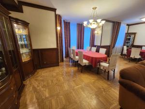 a dining room with a red table and chairs at Пуща Водиця in Vyshhorod