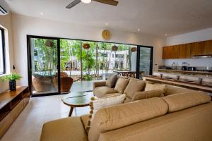uma sala de estar com um sofá e uma mesa em Aqua Viva, Pool, AC, Internet, Beach club em Bacalar
