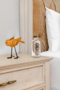 a bottle on a night stand next to a bed at voco Royalty Puebla Downtown in Puebla