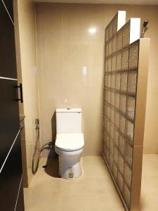 La salle de bains est pourvue de toilettes blanches. dans l'établissement Hollywood Dannok Hotel, à Sadao