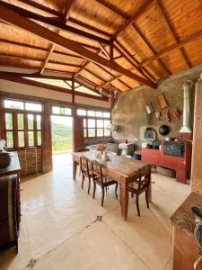 a large kitchen with a wooden table and chairs at Cabana do Lago in Santa Isabel