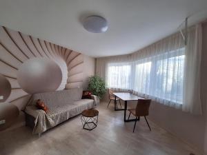 a living room with a couch and a table at Casa Blanca in Wirges
