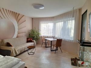 a living room with a couch and a table at Casa Blanca in Wirges