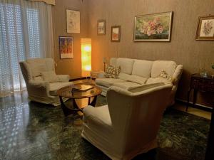 a living room with a couch and chairs and a table at Casa Cele centro città vista mare in Ventimiglia