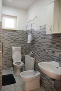 a bathroom with a toilet and a sink at Apartman Mila in Županja