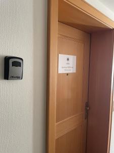 a door with a sign on it and a tv on a wall at Apartment RETRO-Chic in der Fußgängerzone in Bregenz