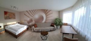 a living room with a bed and a couch at Casa Blanca in Wirges