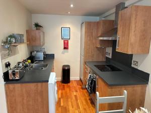 a kitchen with a sink and a counter top at Central 2 Bedroom Apartment - Fast WIFI - Near Broad Street in Birmingham