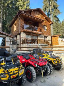 two atvs parked in front of a log cabin at CHALET ELEVEN in Dospat