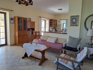 a living room with a couch and a table at PETRINO in Keratokampos +18 photos