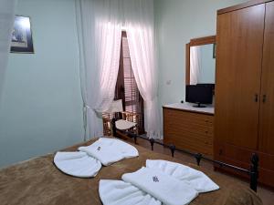 a bedroom with a bed with towels on it at PETRINO in Keratokampos