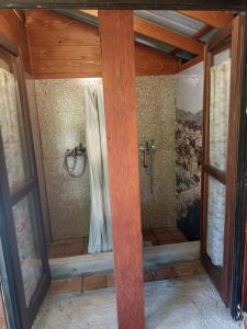 a shower in a room with two windows at Kamp Seosko domaćinstvo Radman in Herceg-Novi