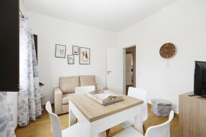 a white living room with a table and chairs at A48 - Windmill 1 Bed Apartment in Odiaxere in Odiáxere