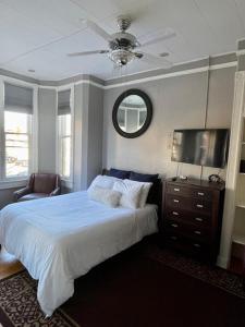 a bedroom with a bed with a ceiling fan and a television at Travelers Delight APT with Amenities, King St 1 mi in Alexandria