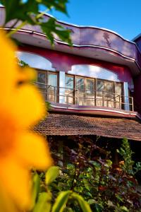 a building with a balcony on top of it at The Flying Squirrel Bandhavgarh in Umariā
