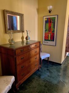 a bedroom with a dresser and a mirror at Casa Cele centro città vista mare in Ventimiglia