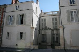 two old buildings with a gate in front of them at Loft de la plage Concurrence in La Rochelle