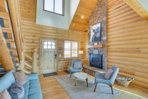 a living room with a blue couch and chairs and a fireplace at Garden City Cabin about 6 Mi to Bear Lake State Park! in Garden City