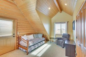 a bedroom with a bed and a chair in a room at Garden City Cabin about 6 Mi to Bear Lake State Park! in Garden City