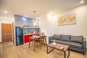 a living room with a couch and a table at La Passion - Tay Ho Hanoi One Bedroom Apartment! in Hanoi