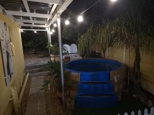 a hot tub in a backyard at night at a Vue Guesthouse in Somerset West