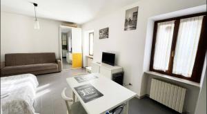 a small living room with a table and a couch at La Piazzetta, il centro di Biella in Biella