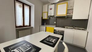 a kitchen with a table and a counter top at La Piazzetta, il centro di Biella in Biella