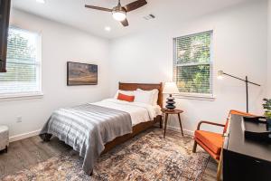 a bedroom with a bed and two windows at Beautiful 3 Bedroom Unit in Austin
