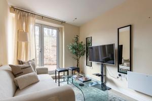 a living room with a couch and a flat screen tv at North London - one bed flat- entire unit in London