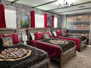a bedroom with two beds and a stone wall at Luxury Lake View 9-Bedroom Villa @Storey Lake Resort in Kissimmee