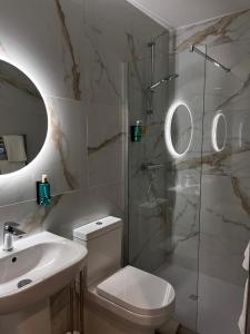 a bathroom with a shower and a toilet and a sink at 53 Luxury Rooms in Maynooth +38 photos
