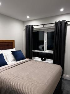 a bedroom with a large bed with a window at 53 Luxury Rooms in Maynooth