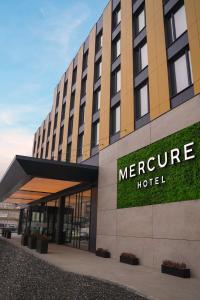 a hotel sign on the side of a building at Mercure Prishtina City in Pristina