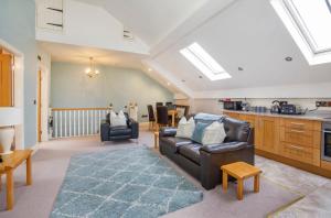 a living room with a couch and a table at Holtby Grange Cottages in York
