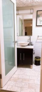 een badkamer met een wastafel en een spiegel bij Huge Downtown LA Loft with Rooftop Pool & Jacuzzi in Los Angeles