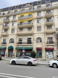 a white car parked in front of a building at Spacious 3 bedroom with sea view in Baku