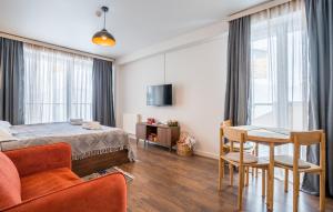 a bedroom with a bed and a table and chairs at New Gudauri Twins Apartment in Gudauri