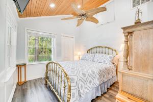 a bedroom with a bed and a ceiling fan at Secluded Florida Retreat on Lake Eloise! in Winter Haven