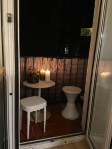 a small bathroom with a toilet and a table with candles at Marina Motel in Marseille