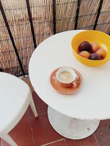 a white table with a bowl of fruit and a bowl of food at Marina Motel in Marseille