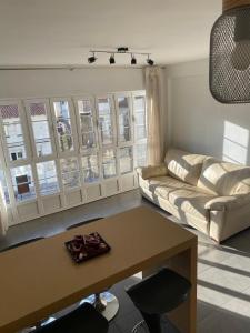a living room with a couch and a table at El mirador de cudillero in Cudillero