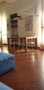 a living room with a wooden floor and a table and chairs at Acquamarina in Rapallo +47 photos