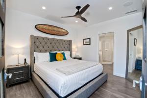 a bedroom with a bed and a ceiling fan at La Costa Luxury Condo - Fully Remodeled in Encinitas