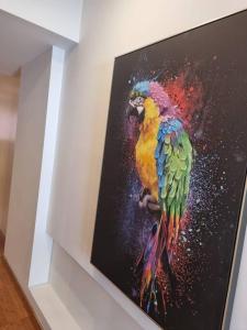 a painting of a colorful parrot on a wall at House of Zoo in Lisbon
