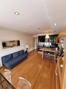 ein Wohnzimmer mit einem blauen Sofa und einem Tisch in der Unterkunft House of Zoo in Lissabon