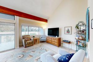 a living room with a couch and a tv at Turnberry Village 258 in Hilton Head Island