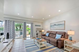 a living room with a couch and a table at La Costa Escape - Pool, BBQ, Gated Parking in Encinitas