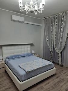 - une chambre avec un lit et un lustre dans l'établissement Welcome home, à Terni