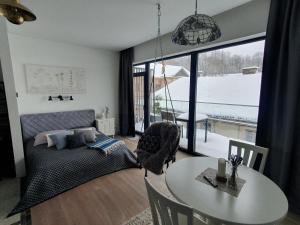 a bedroom with a bed and a table and a window at New cozy apartment in the old town of Vilnius, Paupys in Vilnius