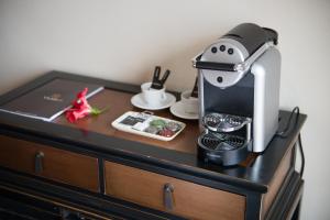 a coffee maker sitting on top of a table at Hotel Boutique Varadero in Zahara de los Atunes